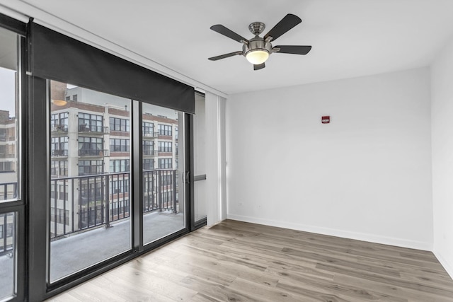 210 S Desplaines St Unit 1102, Chicago, IL 60661 - spare room featuring wood finished floors, baseboards, and a ceiling fan