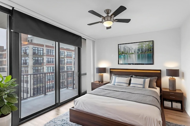 210 S Desplaines St Unit 1102, Chicago, IL 60661 - bedroom with access to exterior, wood finished floors, ceiling fan, and expansive windows