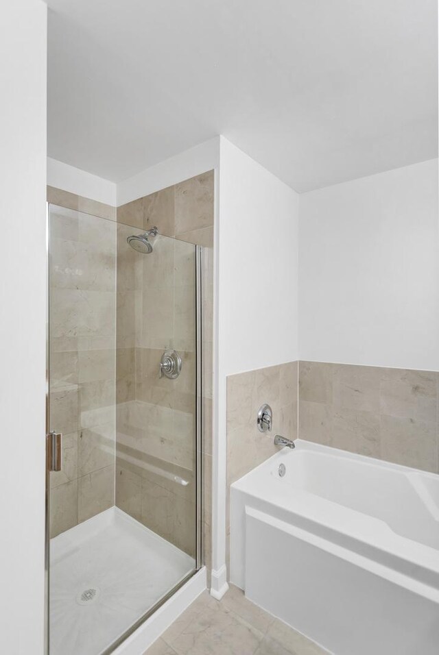 210 S Desplaines St Unit 1102, Chicago, IL 60661 - full bath with a garden tub, a stall shower, and tile patterned flooring