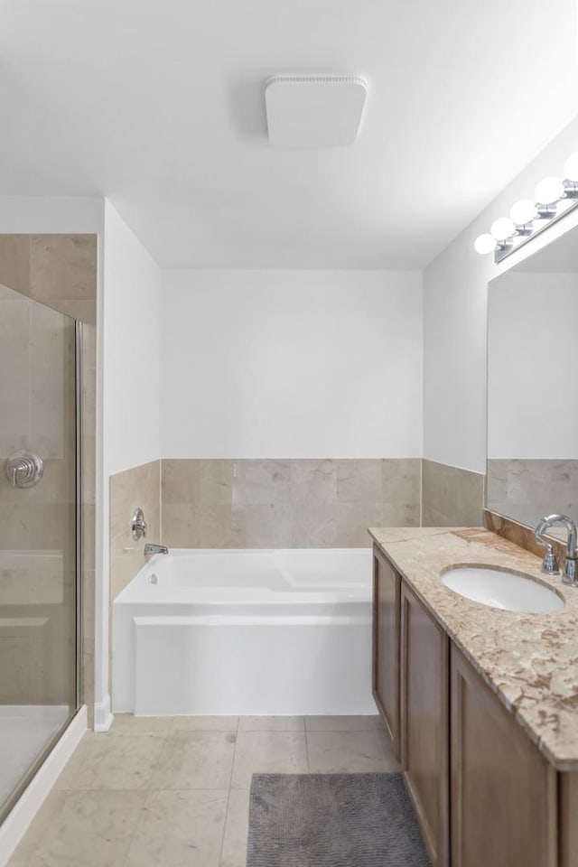 210 S Desplaines St Unit 1102, Chicago, IL 60661 - full bathroom featuring a garden tub, a shower stall, and vanity