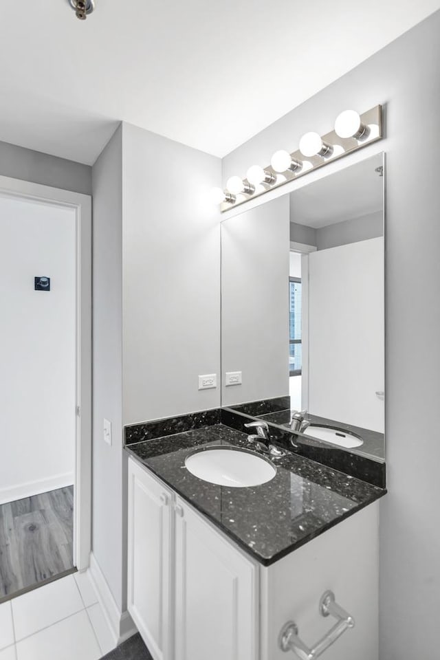 210 S Desplaines St Unit 1102, Chicago, IL 60661 - bathroom with vanity, tile patterned floors, and baseboards