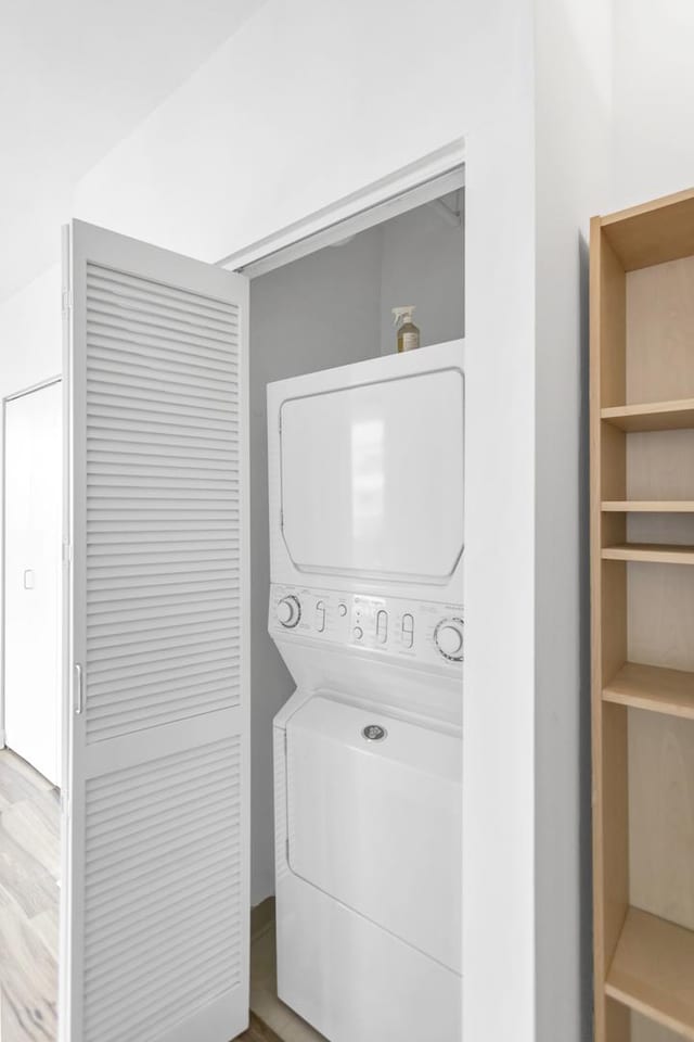 210 S Desplaines St Unit 1102, Chicago, IL 60661 - laundry area featuring estacked washer and dryer and wood finished floors