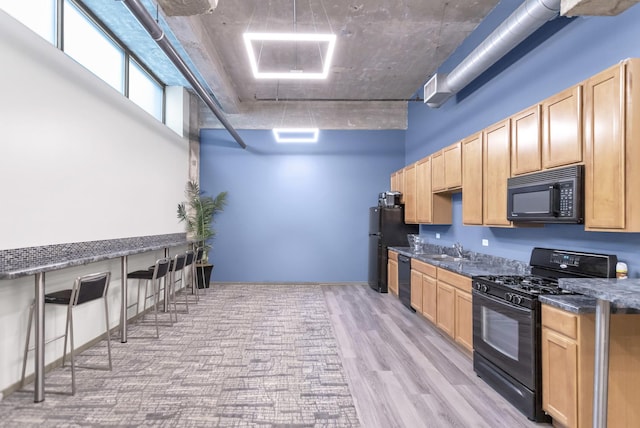 210 S Desplaines St Unit 1102, Chicago, IL 60661 - kitchen with black appliances, light brown cabinets, and a sink