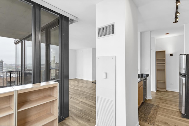 210 S Desplaines St Unit 1102, Chicago, IL 60661 - corridor with light wood-type flooring, baseboards, and track lighting