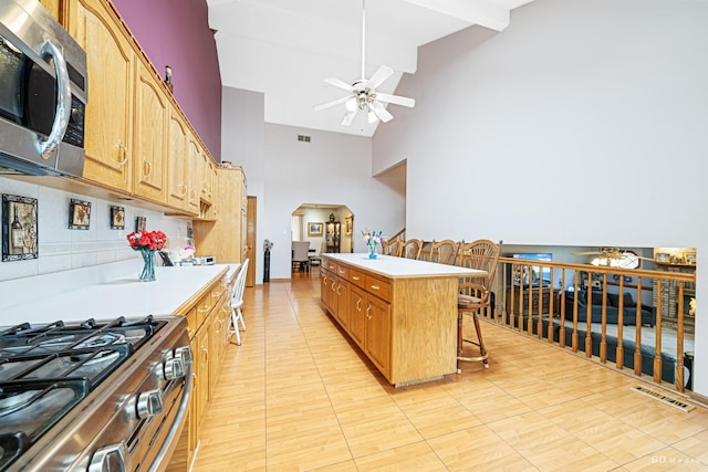 9039 S Central Ave, Oak Lawn, IL 60453 - kitchen with stainless steel appliances, ceiling fan, high vaulted ceiling, light countertops, and a breakfast bar
