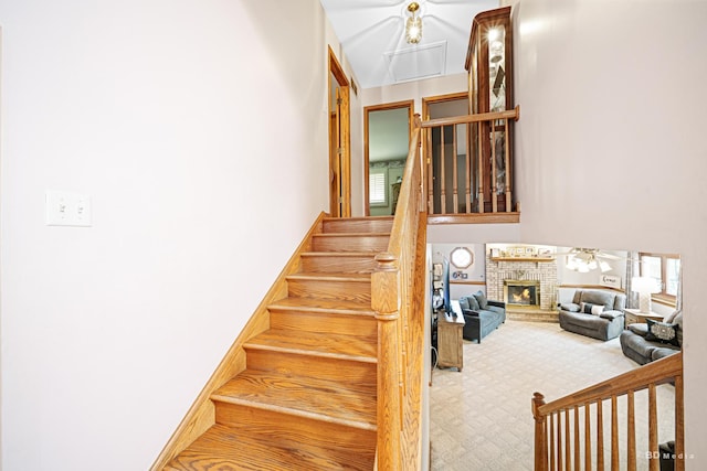 9039 S Central Ave, Oak Lawn, IL 60453 - staircase with attic access, a brick fireplace, a towering ceiling, and carpet