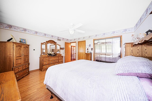 9039 S Central Ave, Oak Lawn, IL 60453 - bedroom featuring light wood-style floors, multiple closets, and a ceiling fan