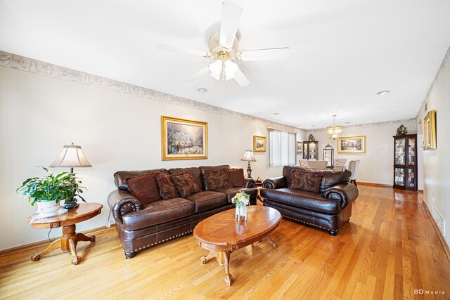 9039 S Central Ave, Oak Lawn, IL 60453 - living area featuring light wood-style floors, baseboards, a chandelier, and a ceiling fan