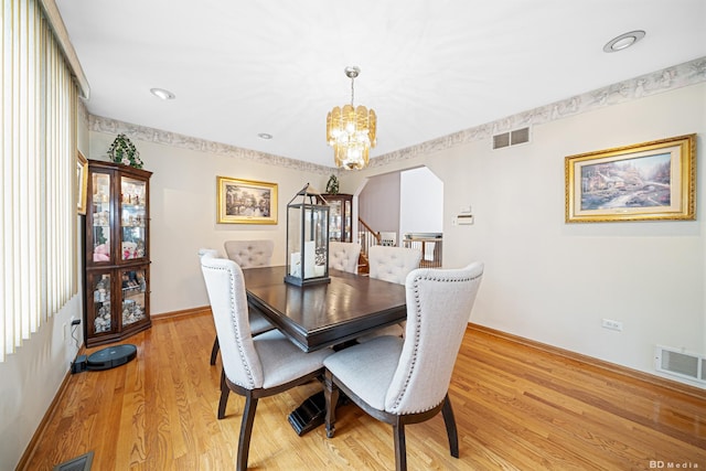 9039 S Central Ave, Oak Lawn, IL 60453 - dining space featuring a chandelier, light wood-type flooring, baseboards, and stairway