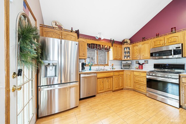 9039 S Central Ave, Oak Lawn, IL 60453 - kitchen with stainless steel appliances, vaulted ceiling, decorative backsplash, light countertops, and a sink