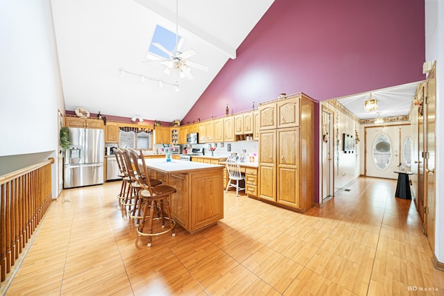 9039 S Central Ave, Oak Lawn, IL 60453 - kitchen featuring appliances with stainless steel finishes, light countertops, a center island, ceiling fan, and a breakfast bar
