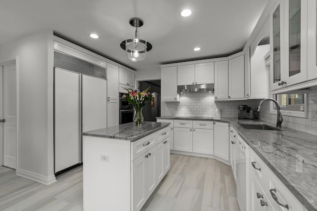 1682 Cavell Ave, Highland Park, IL 60035 - kitchen with paneled refrigerator, a sink, under cabinet range hood, recessed lighting, and white cabinets