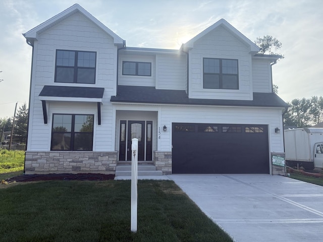 154 Pine Ln, Wood Dale, IL 60191 - view of front of property with an attached garage, concrete driveway, a front lawn, and stone siding