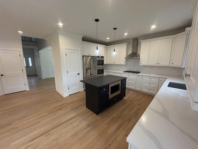 154 Pine Ln, Wood Dale, IL 60191 - kitchen with wall chimney range hood, appliances with stainless steel finishes, tasteful backsplash, light wood-style flooring, and a center island