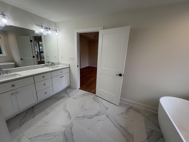 154 Pine Ln, Wood Dale, IL 60191 - bathroom with baseboards, double vanity, a soaking tub, and marble finish flooring