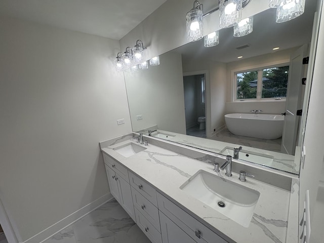 154 Pine Ln, Wood Dale, IL 60191 - bathroom featuring marble look tiles, baseboards, a soaking tub, double vanity, and toilet