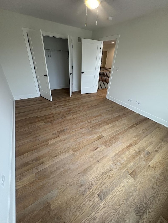 154 Pine Ln, Wood Dale, IL 60191 - unfurnished bedroom featuring wood finished floors, baseboards, and a closet