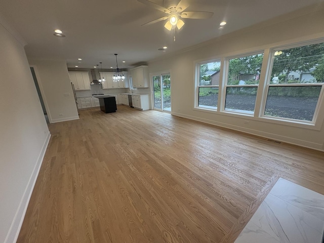 154 Pine Ln, Wood Dale, IL 60191 - unfurnished living room featuring baseboards, light wood-style flooring, a chandelier, ceiling fan, and ornamental molding