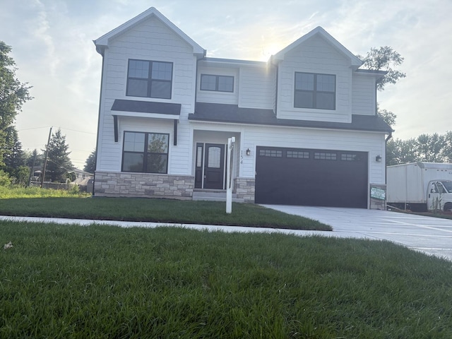 154 Pine Ln, Wood Dale, IL 60191 - view of front of house featuring a garage, concrete driveway, stone siding, and a front yard