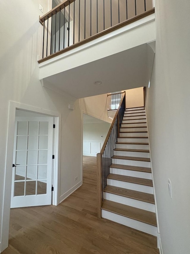 154 Pine Ln, Wood Dale, IL 60191 - stairs featuring a towering ceiling, wood finished floors, and baseboards