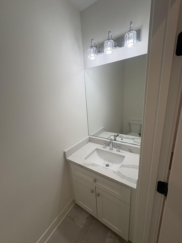 154 Pine Ln, Wood Dale, IL 60191 - half bathroom with baseboards, vanity, toilet, and marble finish floors