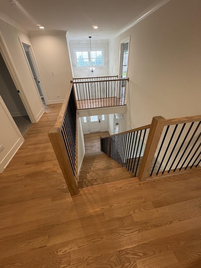 154 Pine Ln, Wood Dale, IL 60191 - stairway featuring ornamental molding, wood finished floors, a chandelier, baseboards, and recessed lighting