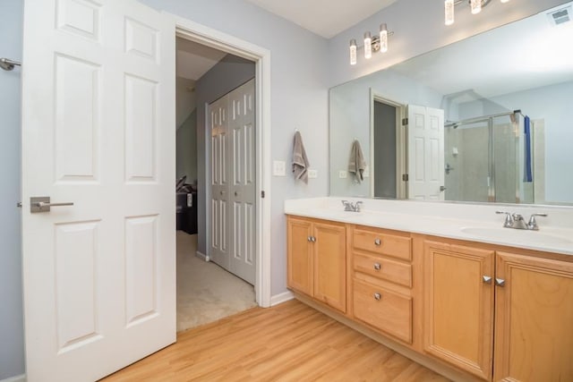1040 Fairway Dr, Fox Lake, IL 60020 - full bathroom featuring double vanity, a stall shower, and wood finished floors