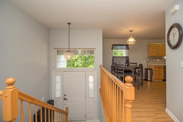 1040 Fairway Dr, Fox Lake, IL 60020 - foyer entrance featuring light wood-style flooring, a chandelier, and baseboards