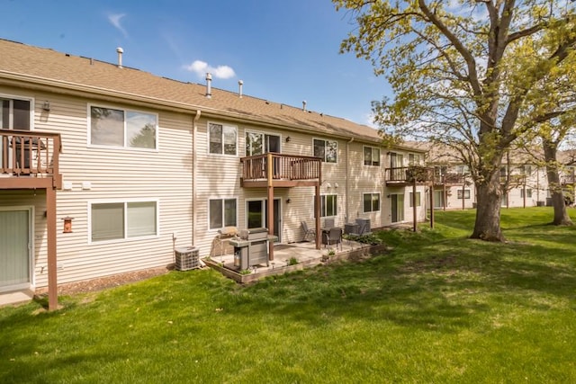 1040 Fairway Dr, Fox Lake, IL 60020 - rear view of house featuring a lawn, a patio, central AC, and a balcony