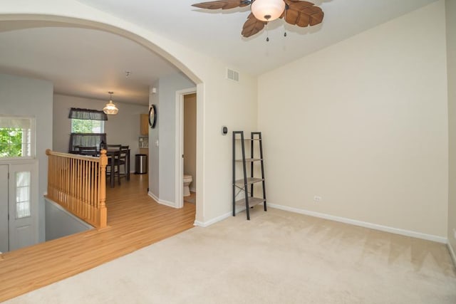 1040 Fairway Dr, Fox Lake, IL 60020 - spare room with arched walkways, ceiling fan, carpet, and baseboards