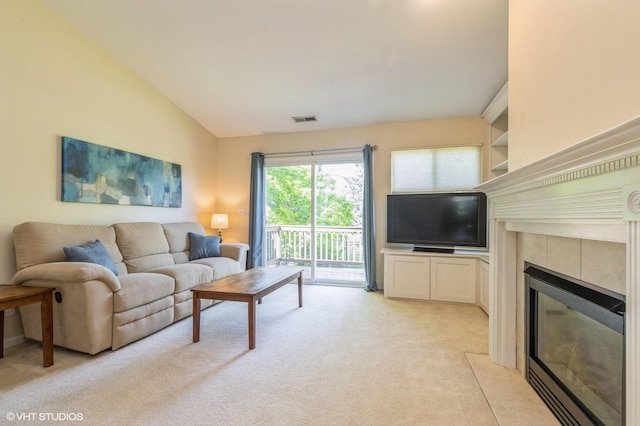 1040 Fairway Dr, Fox Lake, IL 60020 - living room featuring light carpet, a tiled fireplace, vaulted ceiling, and built in features