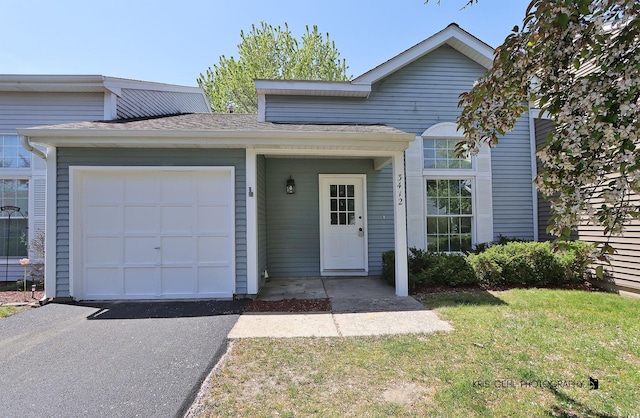 3412 Greenwich Ln, Island Lake, IL 60042 - traditional home featuring a garage, a front yard, asphalt driveway, and roof with shingles