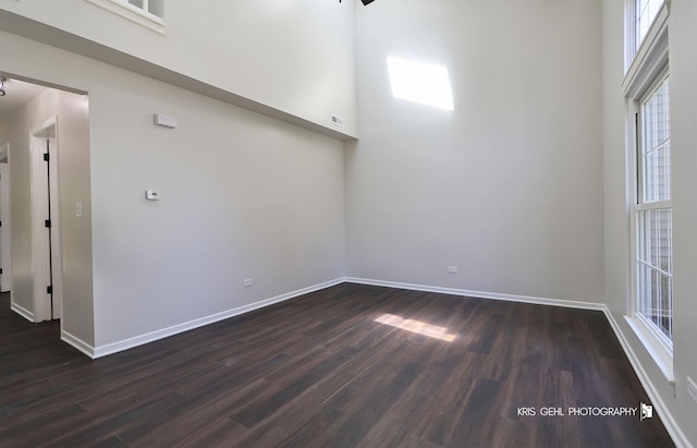 3412 Greenwich Ln, Island Lake, IL 60042 - spare room with dark wood-style flooring, baseboards, and a towering ceiling