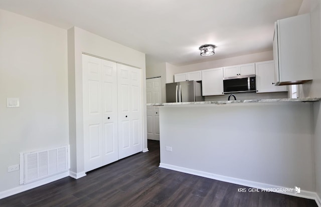 3412 Greenwich Ln, Island Lake, IL 60042 - kitchen with appliances with stainless steel finishes, white cabinetry, dark wood-style floors, and baseboards