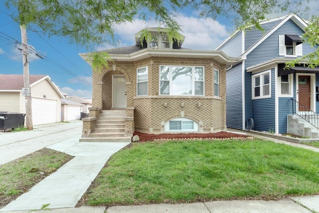 4345 N Mcvicker Ave, Chicago, IL 60634 - view of front facade with brick siding, entry steps, a front yard, and an outbuilding
