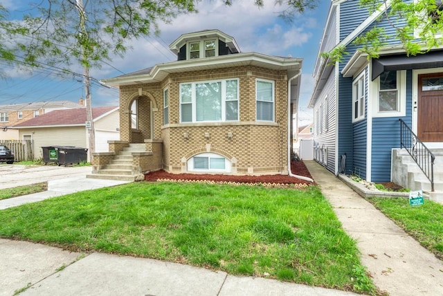 4345 N Mcvicker Ave, Chicago, IL 60634 - bungalow-style house with brick siding, a front lawn, and entry steps