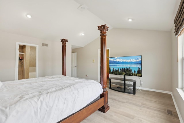 bedroom with light wood-style flooring, lofted ceiling, and baseboards