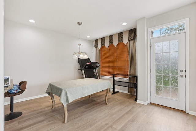 dining area featuring light wood-style flooring, baseboards, and recessed lighting