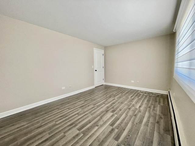 1258 Brown St Unit 302, Des Plaines, IL 60016 - empty room with a baseboard radiator, dark wood-style floors, and baseboards