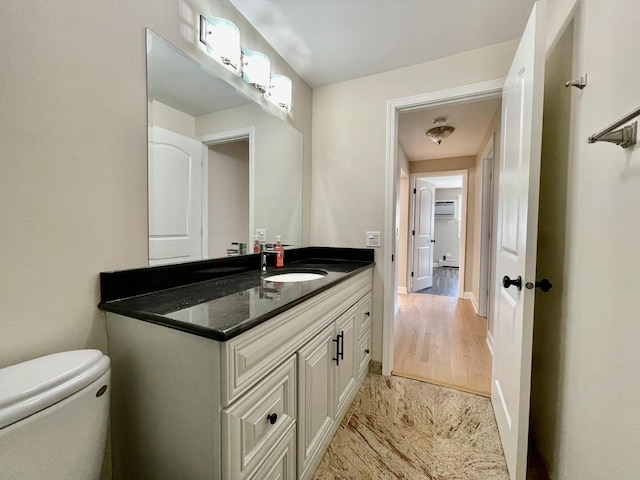 1258 Brown St Unit 302, Des Plaines, IL 60016 - half bathroom with toilet, vanity, wood finished floors, and baseboards