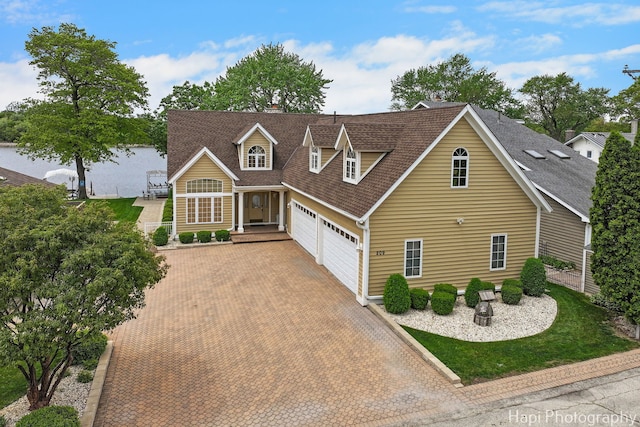 209 S Emerald Dr, Mchenry, IL 60051 - view of front of home featuring an attached garage, roof with shingles, and decorative driveway