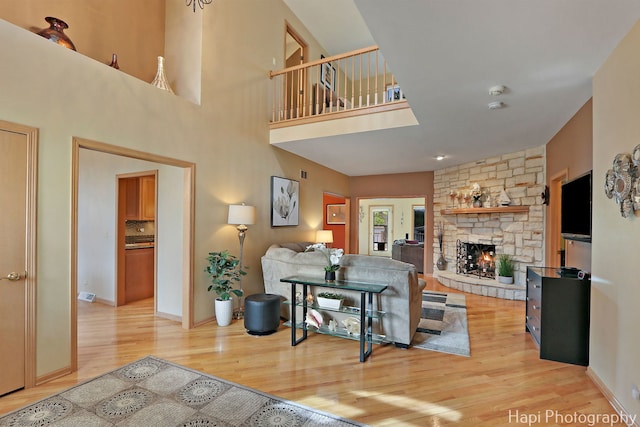 209 S Emerald Dr, Mchenry, IL 60051 - living area with wood finished floors, a stone fireplace, and baseboards