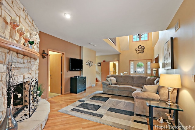 209 S Emerald Dr, Mchenry, IL 60051 - living room with wood finished floors, a stone fireplace, and stairway