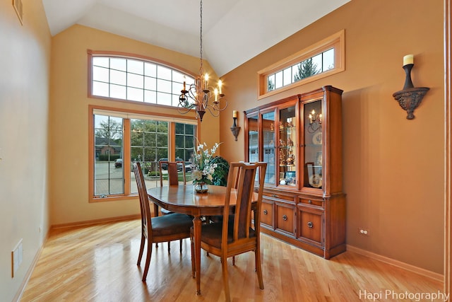 209 S Emerald Dr, Mchenry, IL 60051 - dining room featuring plenty of natural light, a chandelier, light wood finished floors, baseboards, and high vaulted ceiling