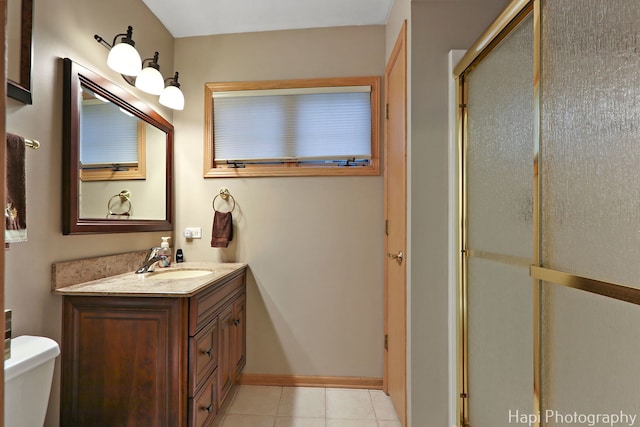 209 S Emerald Dr, Mchenry, IL 60051 - full bathroom featuring a stall shower, toilet, vanity, tile patterned flooring, and baseboards