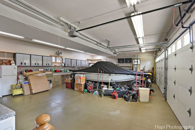 209 S Emerald Dr, Mchenry, IL 60051 - garage with freestanding refrigerator and a garage door opener