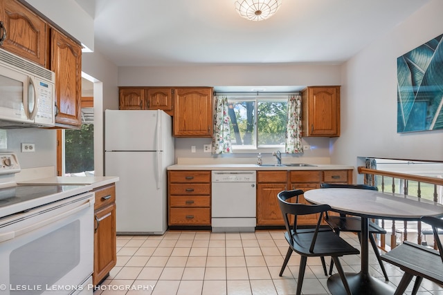 1260 Kent Ct, Wheaton, IL 60189 - kitchen with white appliances, a sink, light countertops, brown cabinets, and light tile patterned flooring