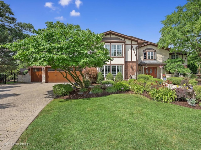 6 Swaps Ct, Oak Brook, IL 60523 - tudor-style house with decorative driveway, stone siding, a front yard, and stucco siding