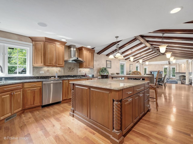 6 Swaps Ct, Oak Brook, IL 60523 - kitchen featuring appliances with stainless steel finishes, wall chimney range hood, light wood-type flooring, a center island, and decorative backsplash