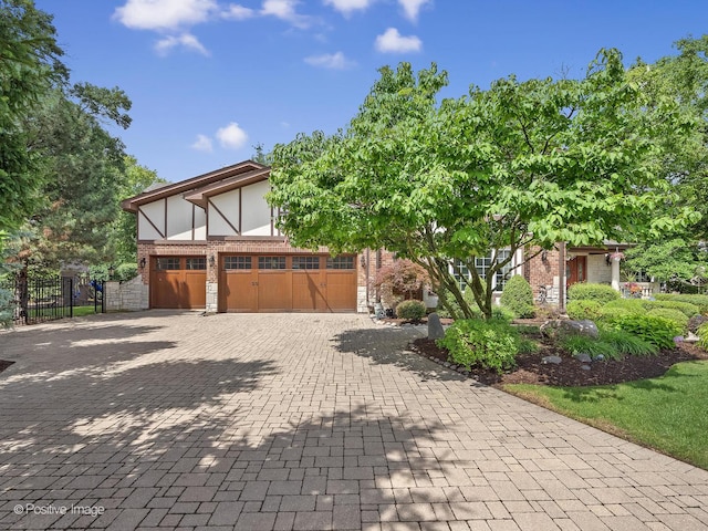 6 Swaps Ct, Oak Brook, IL 60523 - view of home's exterior featuring decorative driveway, stone siding, a garage, and brick siding